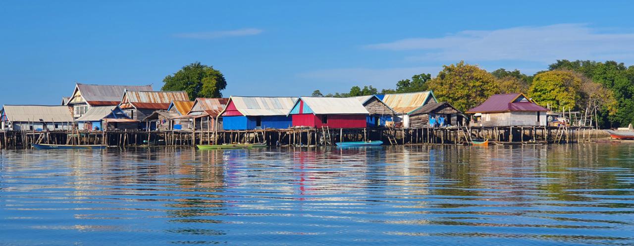 A landscape image of water and buildings by the sea.