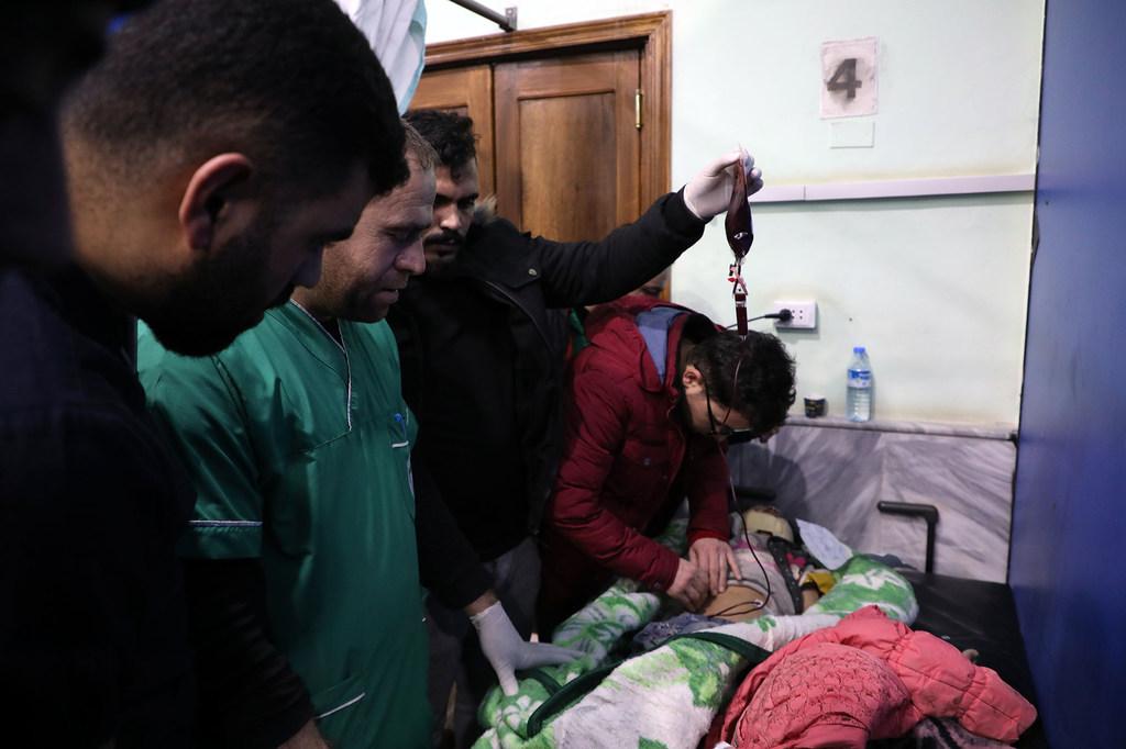 Healthcare workers treating a child injured by the earthquake