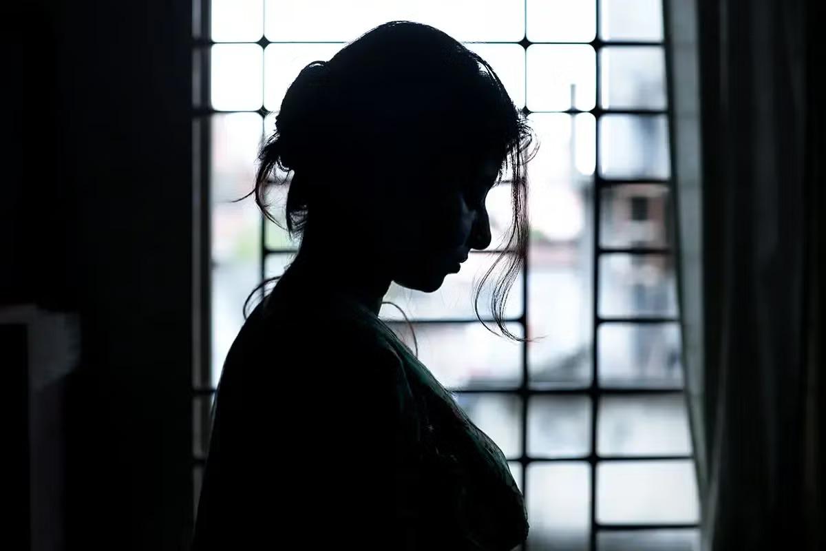 A shadowed woman.