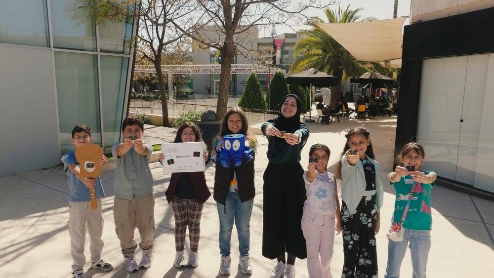 Youth in Jordan show their upcycled electronic components.