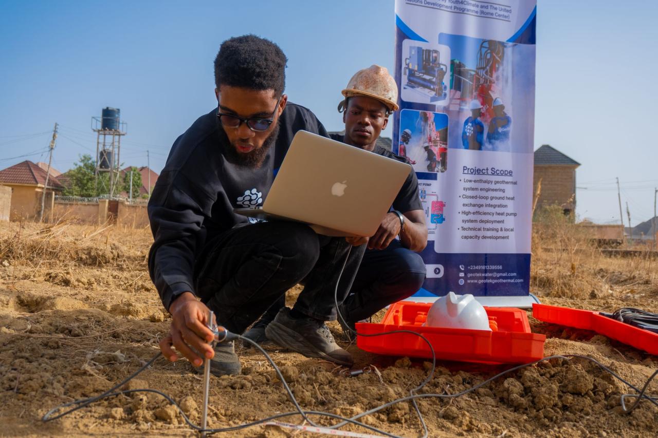 Two young men in Nigeria carry out an assessment for a potential geothermal exploration.