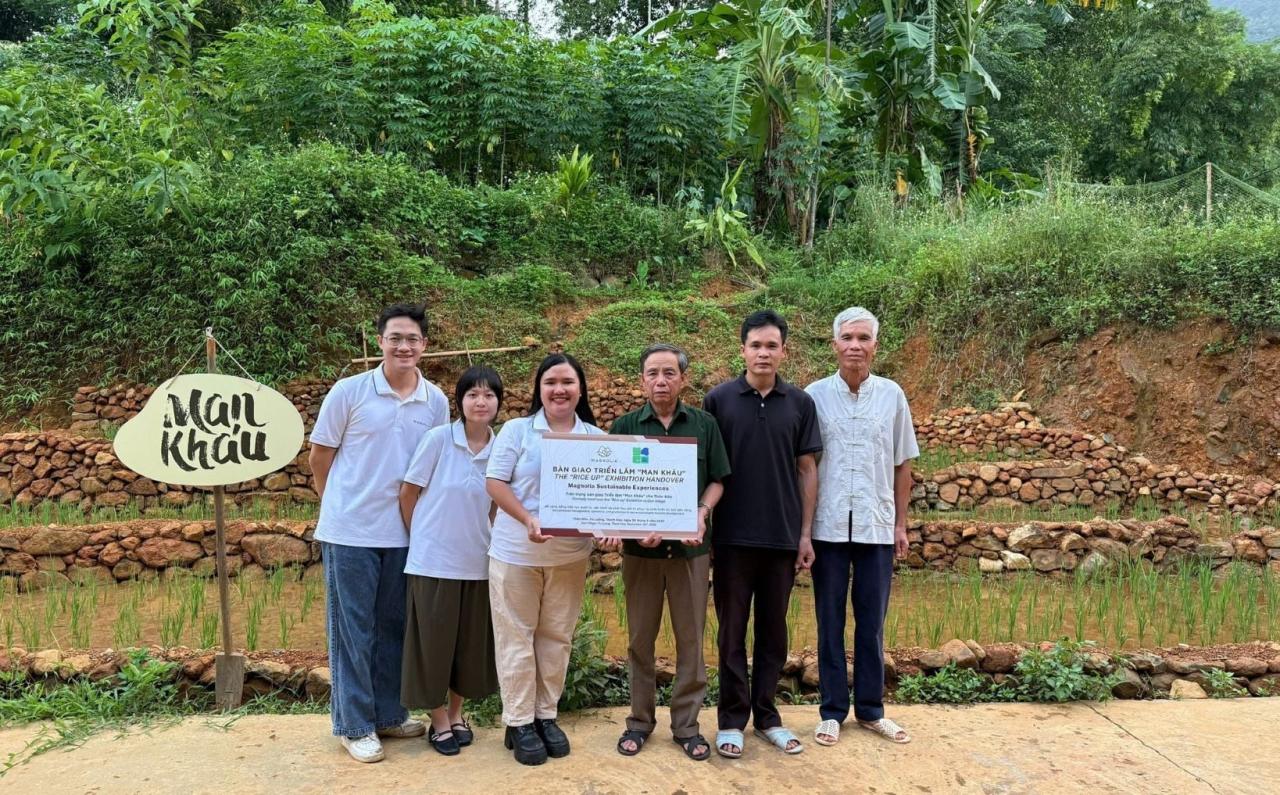 A young leader in Viet Nam with local community members during a handover ceremony of an exhibition she created.