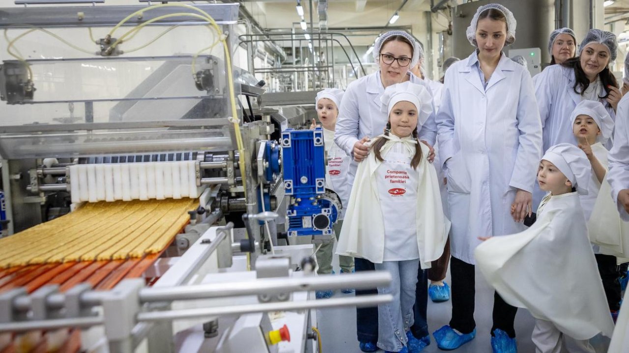 Women at work in a factory with their children, who were provided child-friendly spaces.