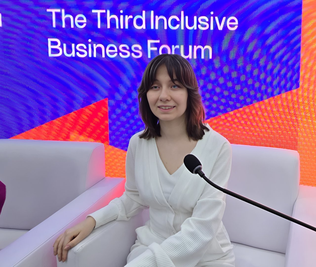 A UN disability inclusion volunteer speaks at a business forum.