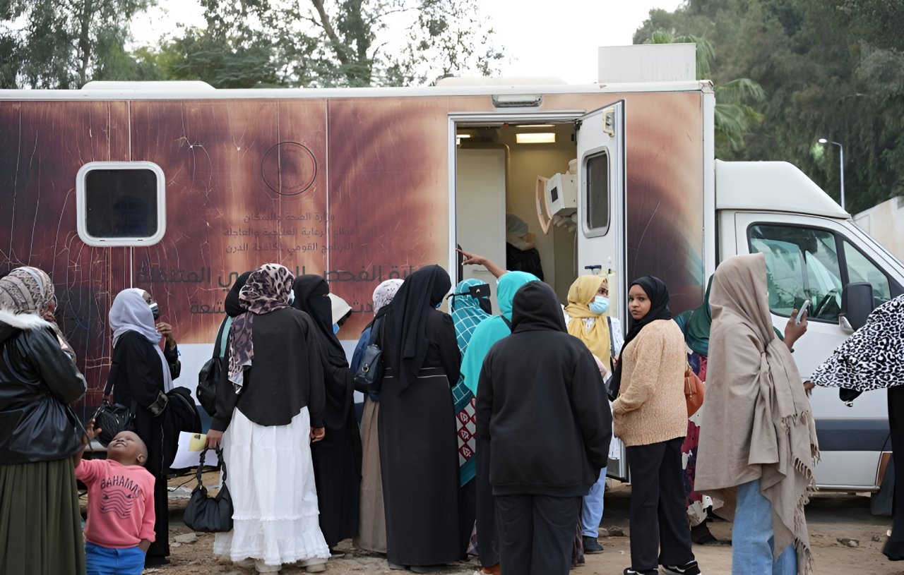 Refugee women board a bus in Egypt.