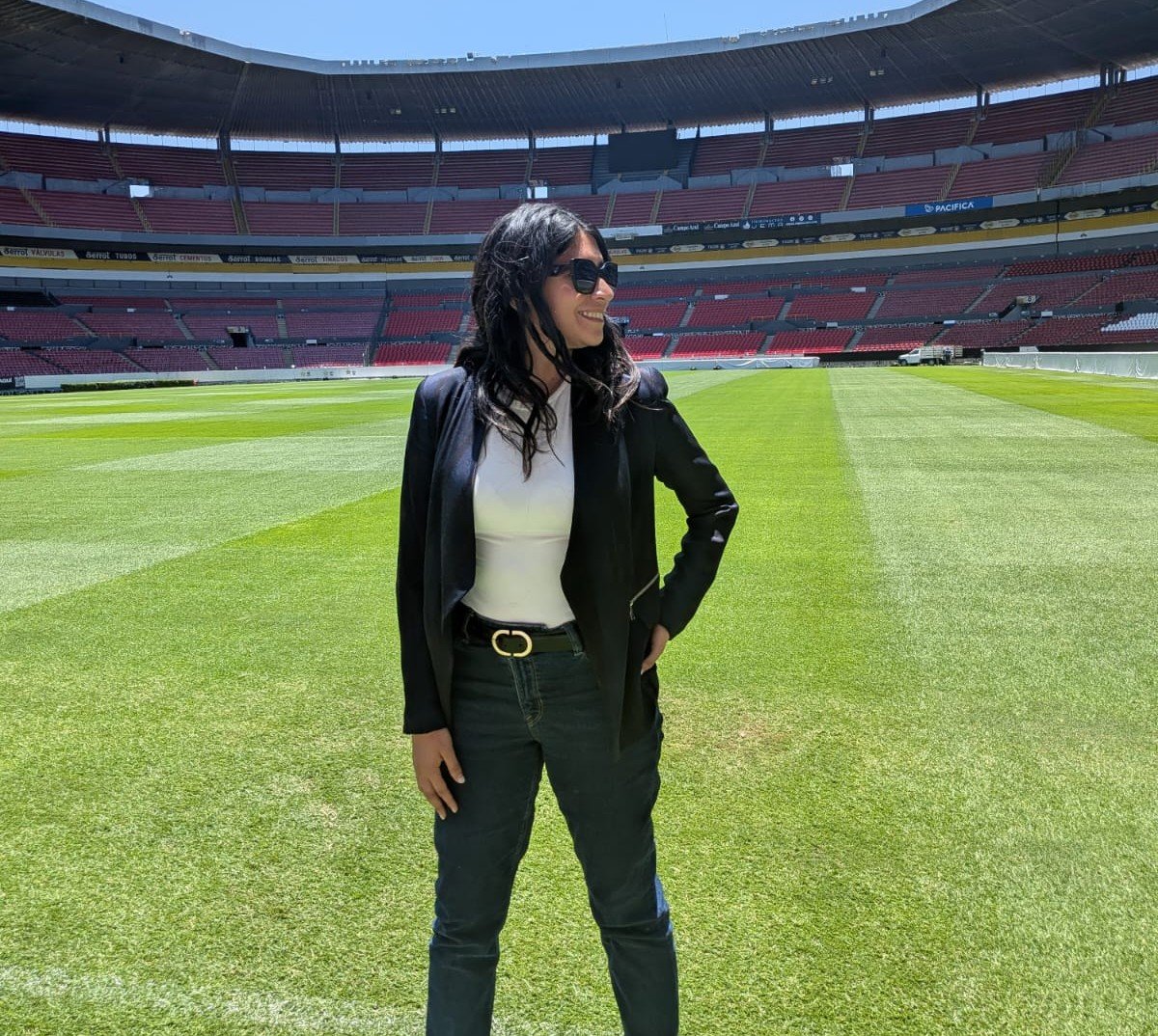 A UN Volunteer stands in a football stadium in Mexico.