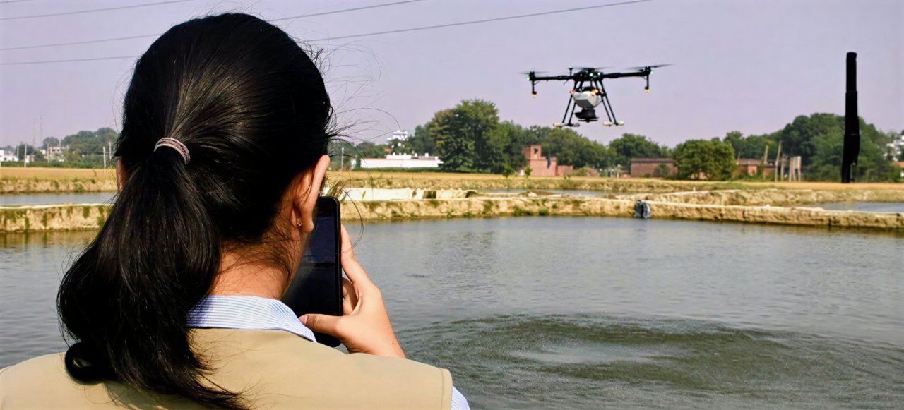 A woman takes a photo of a drone.