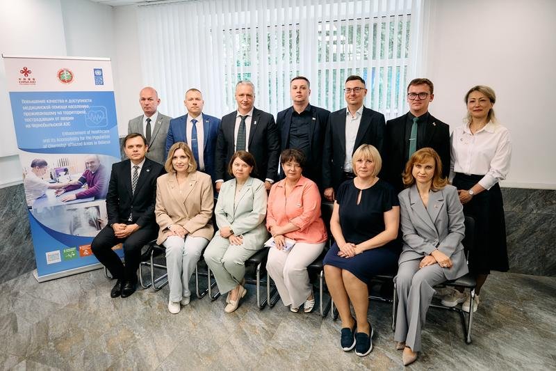 Участники встречи торжественно фотографируются у плаката