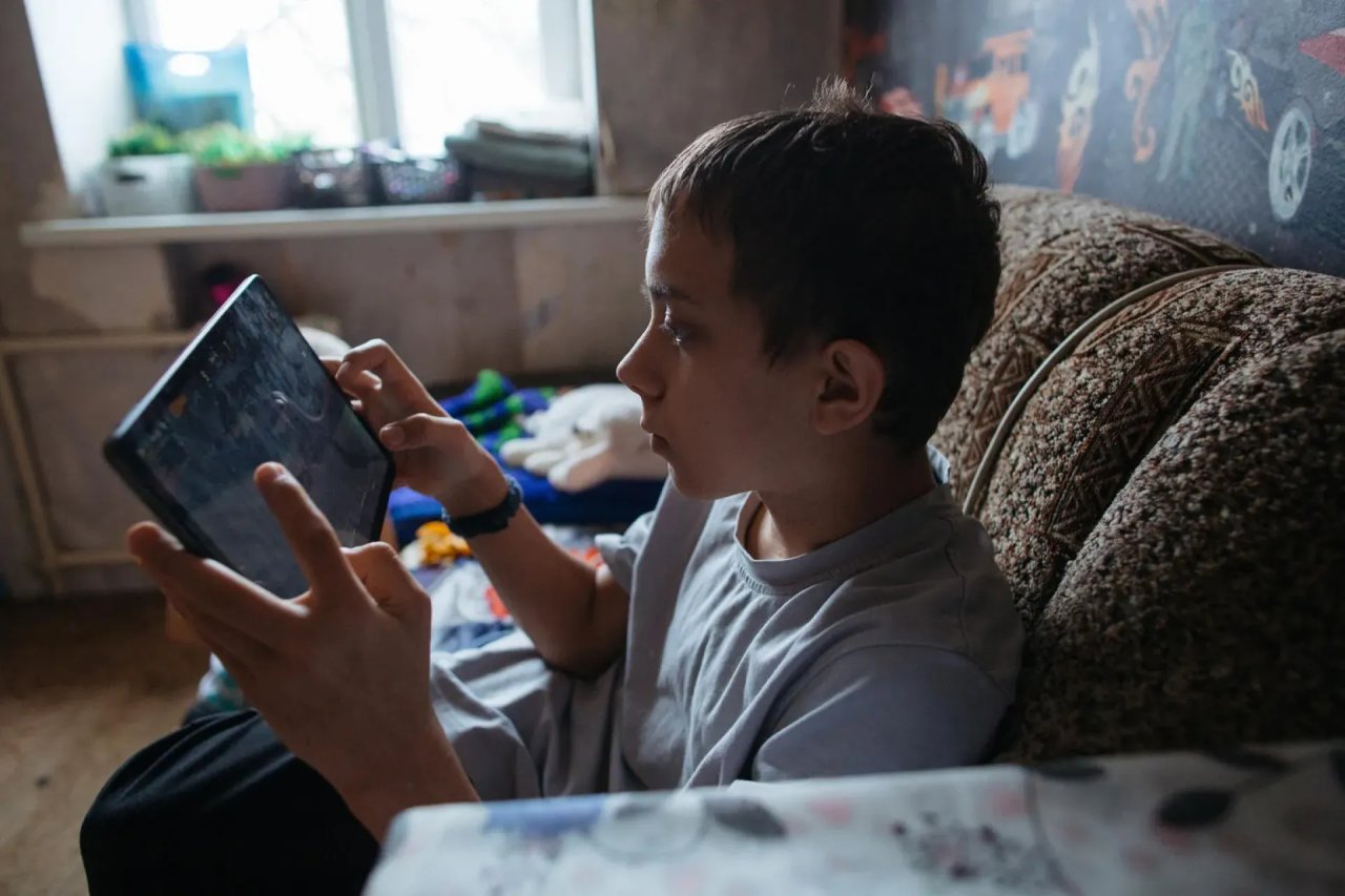 A boy uses a tablet.