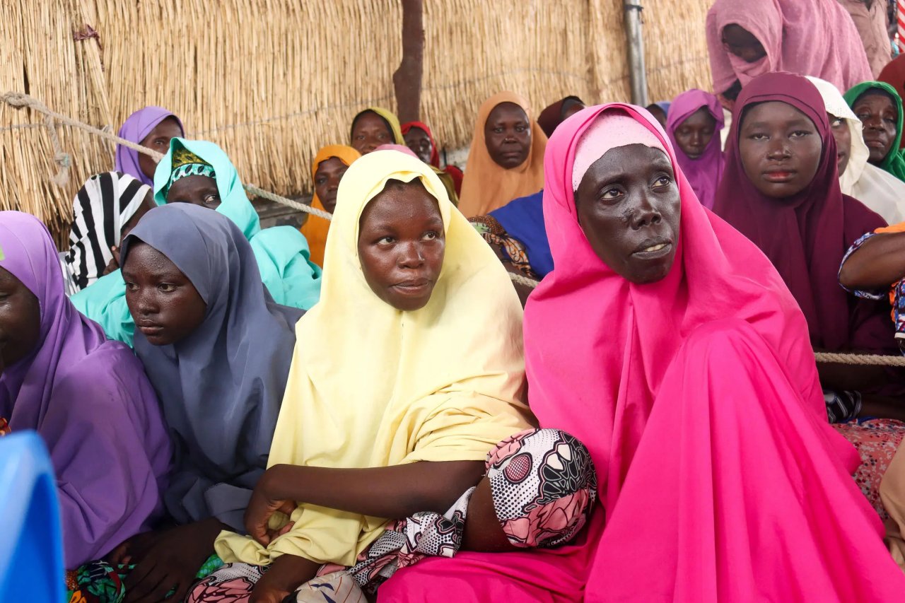 Women-led households await verification before using the e-vouchers to choose food items that best meet their families' nutritional needs.
