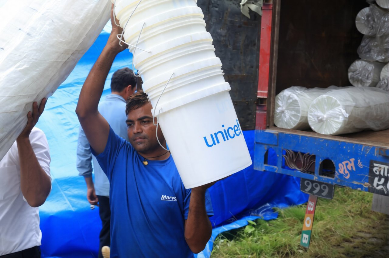 Aid workers in Nepal distribute supplies.