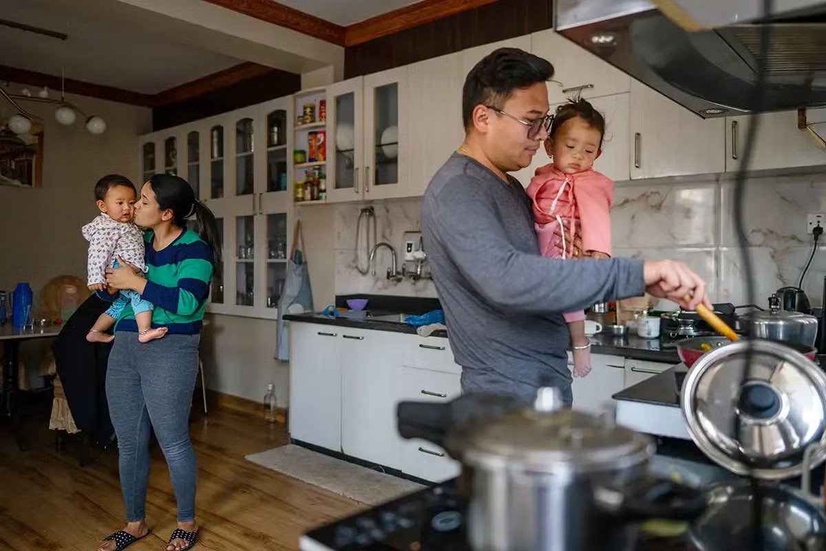 A family in Nepal in a kitchen.