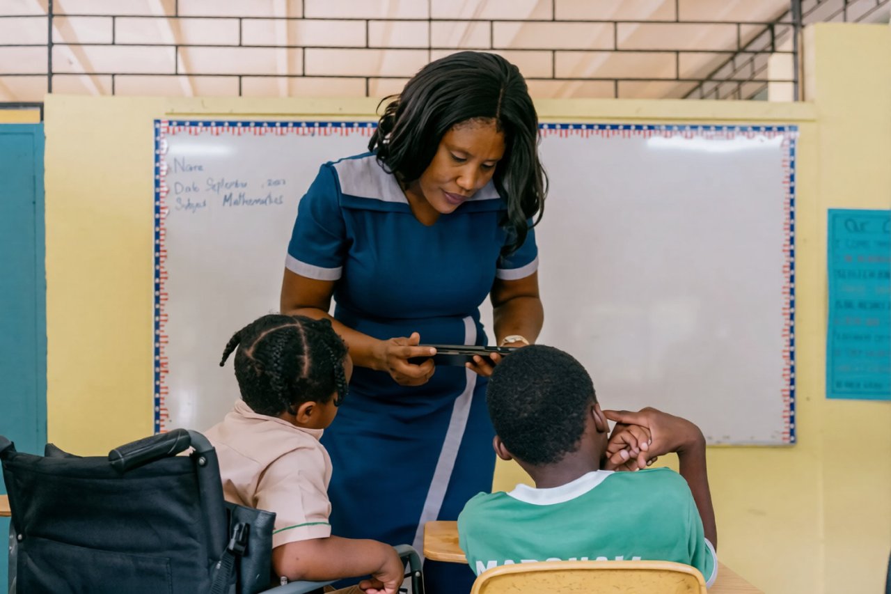A teacher in Jamaica with two students.