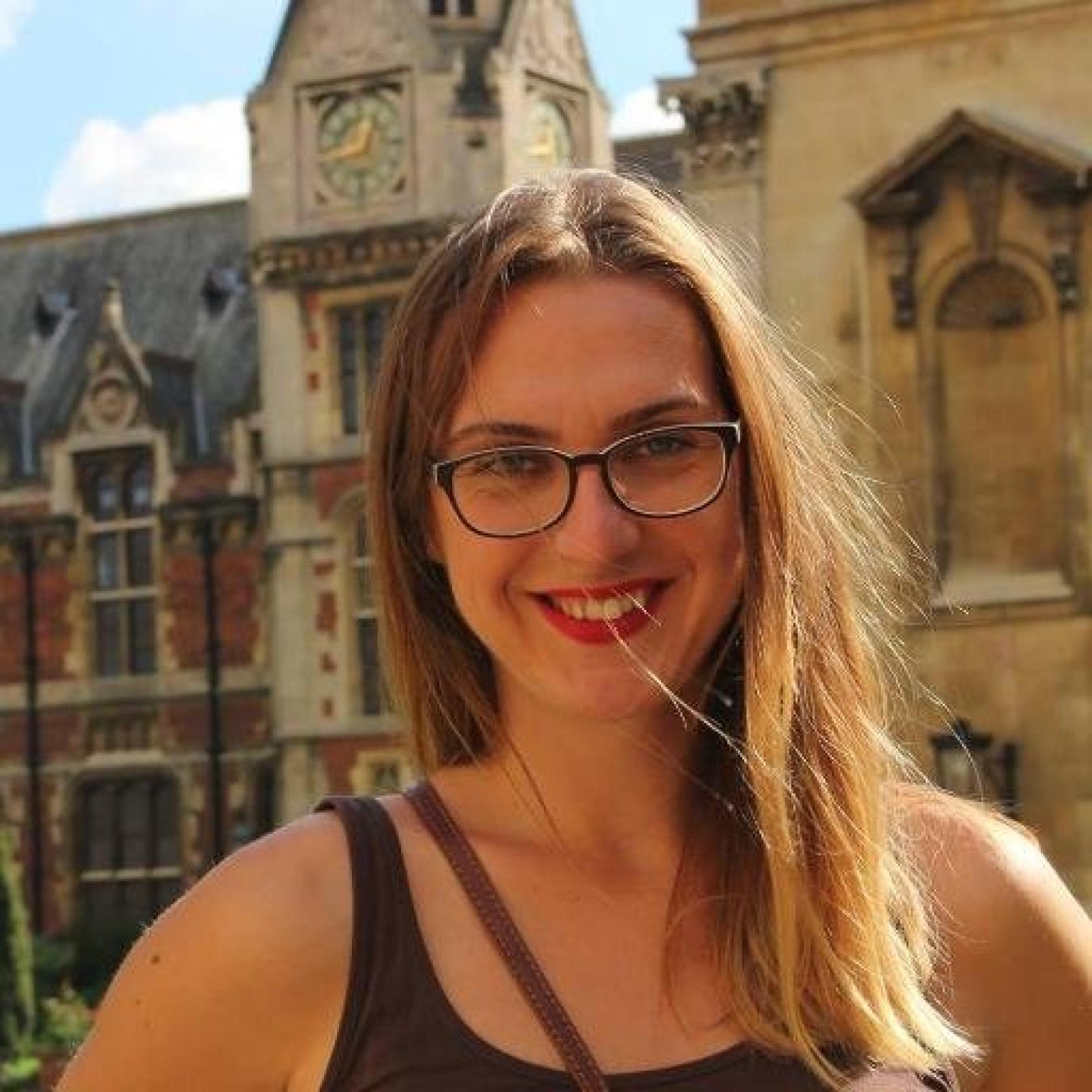 Sofija Bogeva, coordinator of Skopje Lab smiles at the camera as she stands in front of a building.