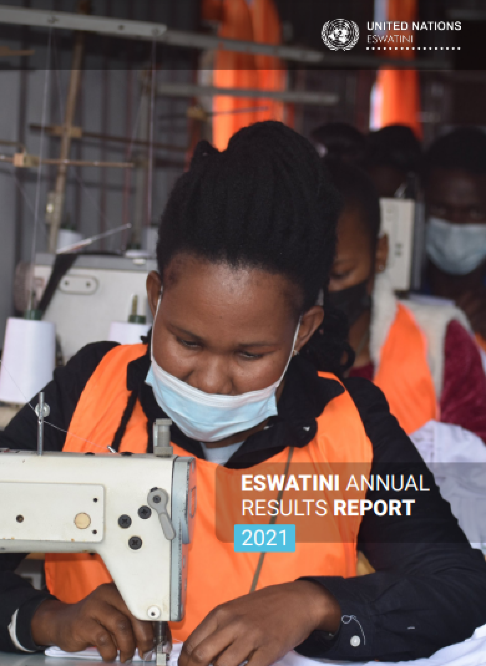 A woman in an orange and black top sews something on a sewing machine.