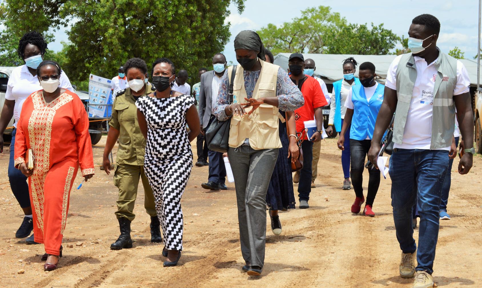 Resident Coordinator in Uganda Susan Namondo walking with officials and community members