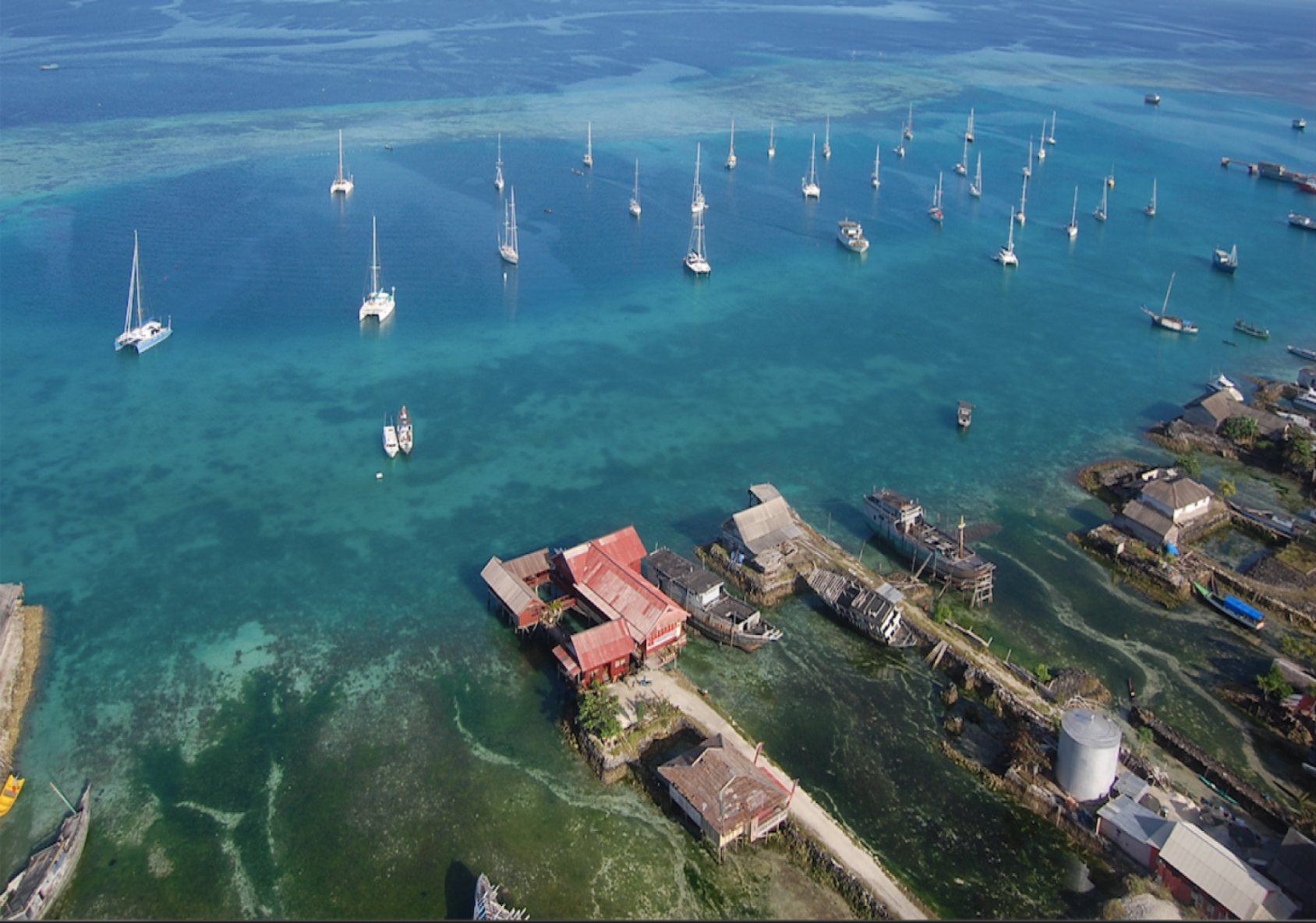 A bay or marina, with ships dotting the horizon near the coast