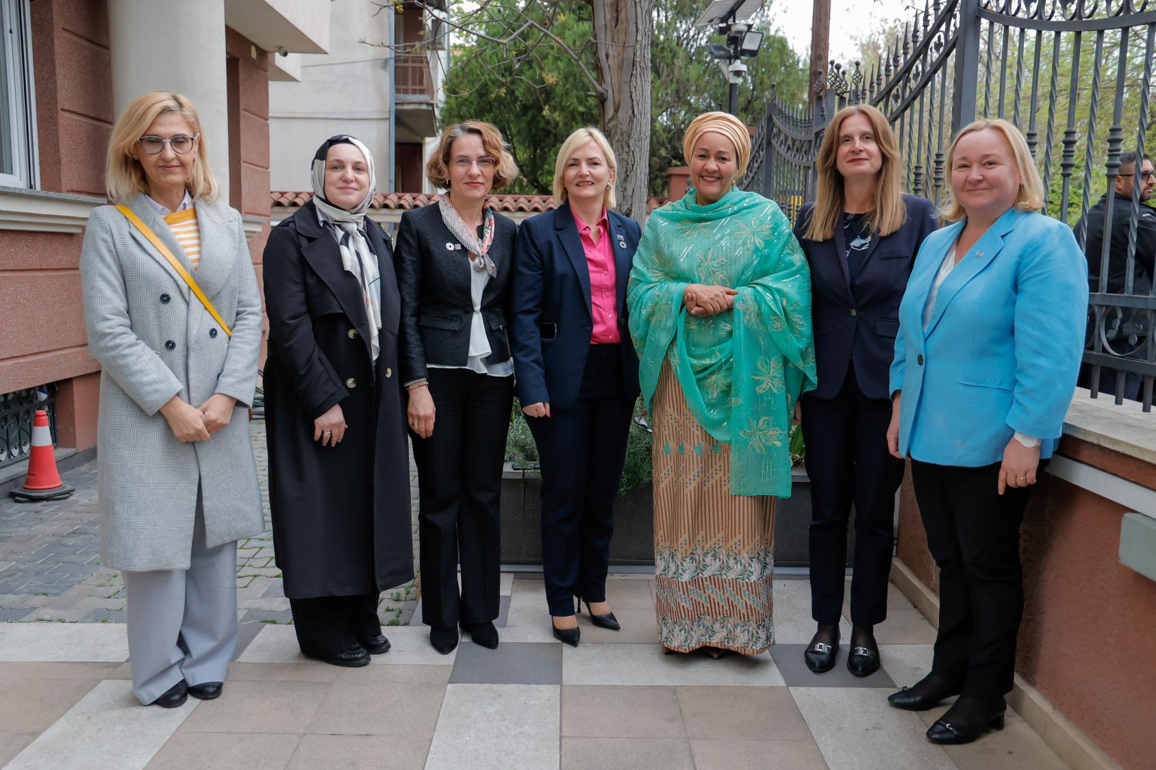 A group of seven women stand together