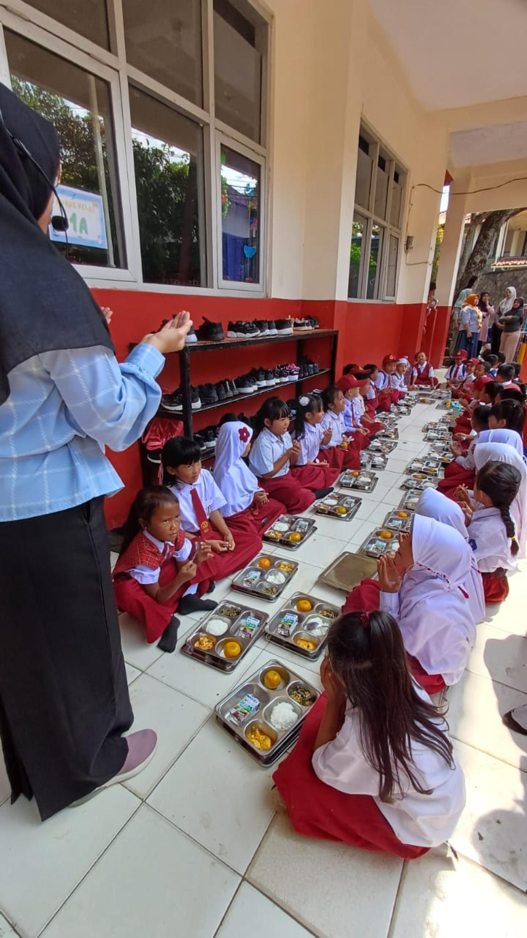 A group of children eating on the floor