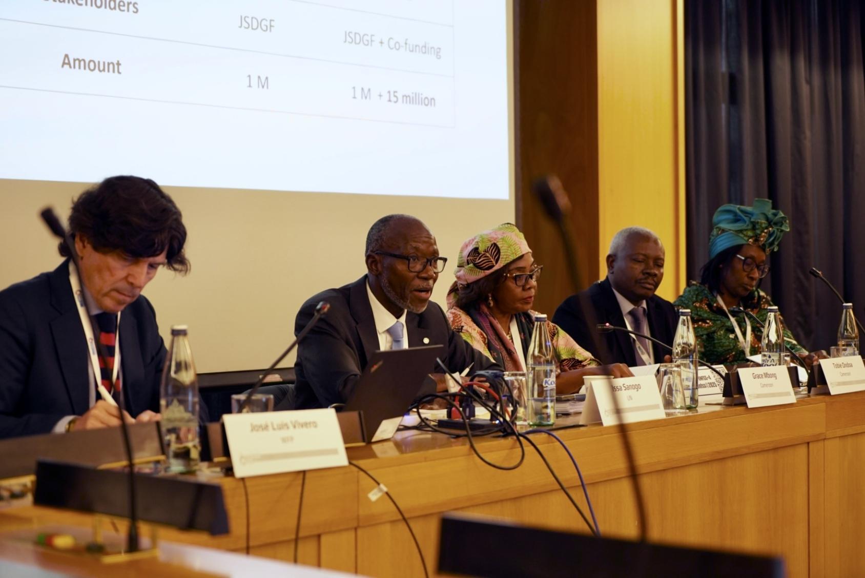 A group of people seated at a table presenting to a large audience