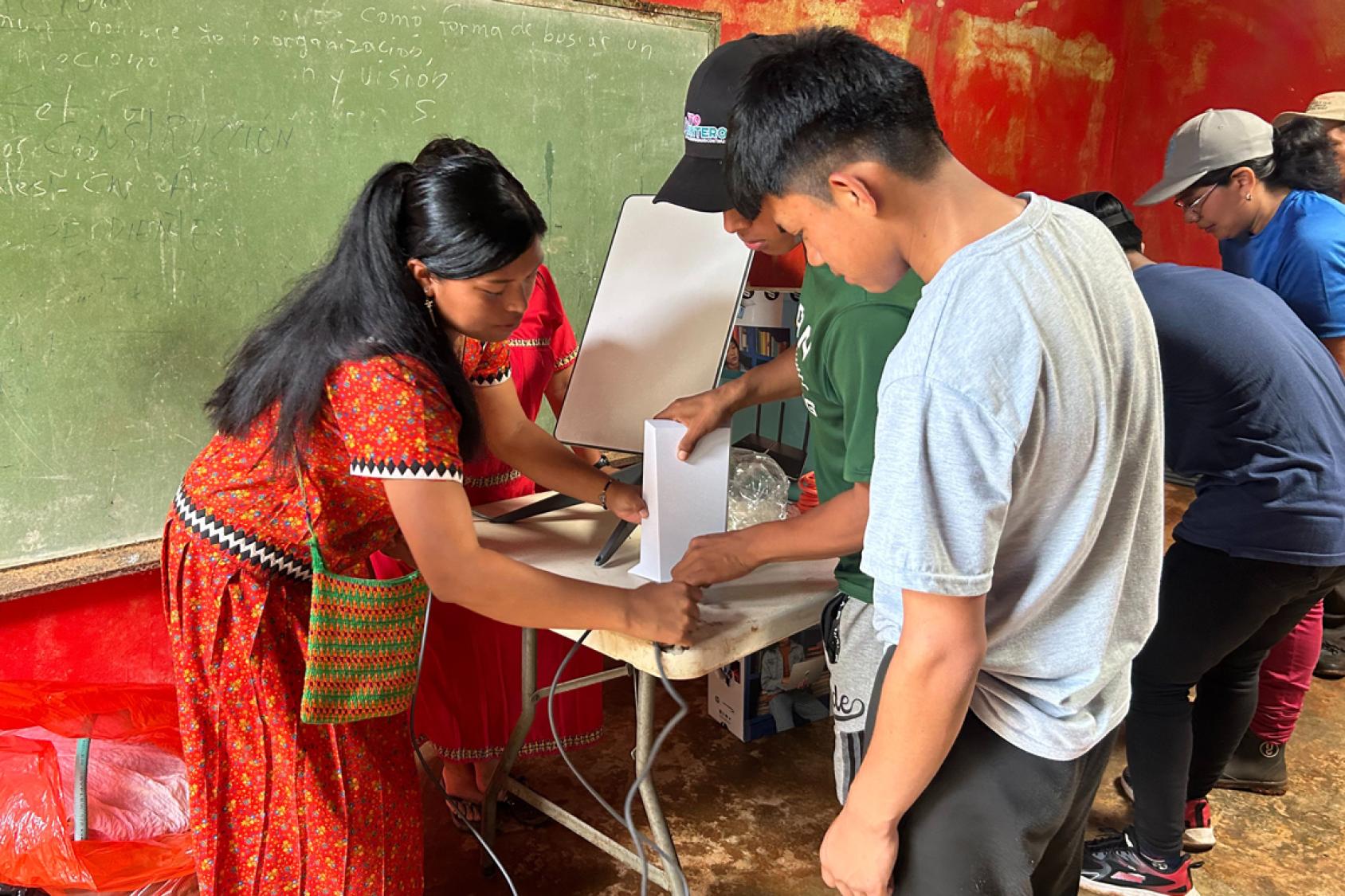 3 people are working together.