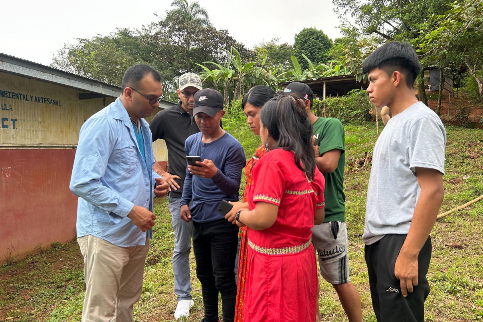 People are looking at the phone screen.