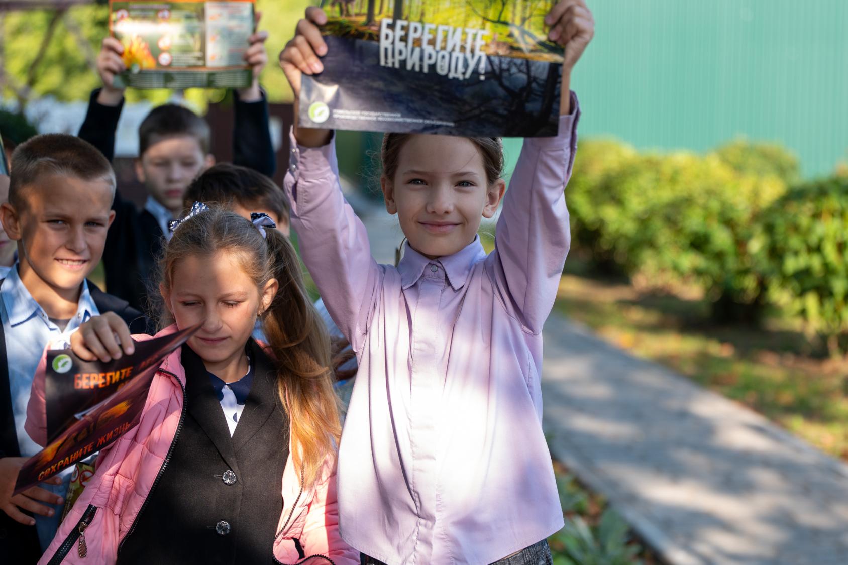 Дети стоят на улице и держат плакаты о защите окружающей среды