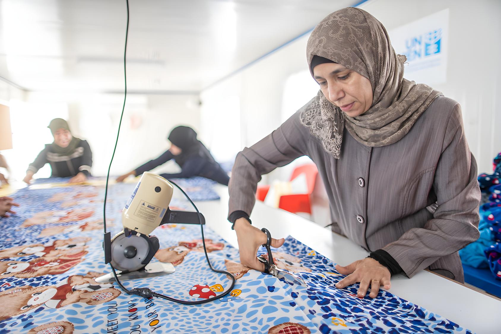 A woman in Jordan sews a cloth.