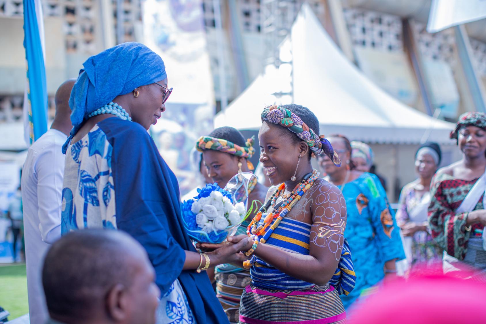 A young Togolese woman talks to another woman.