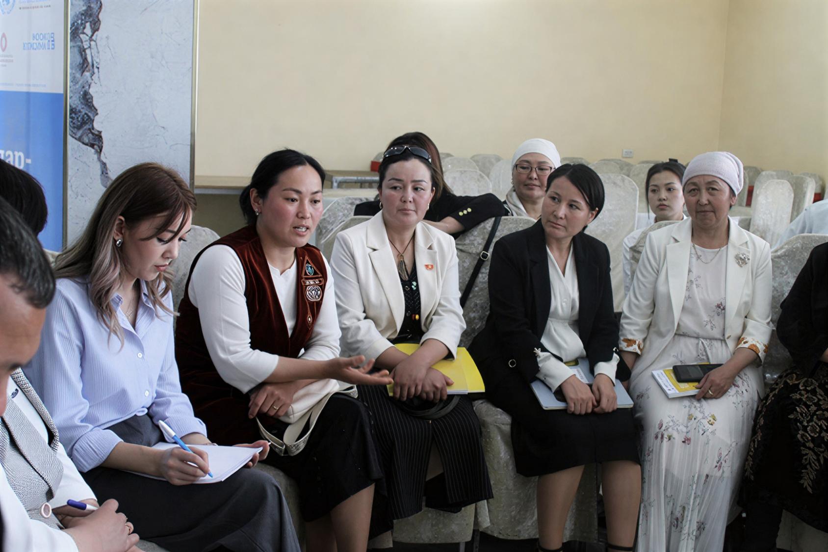 A group of women in Kyrgyzstan hold a small meeting.