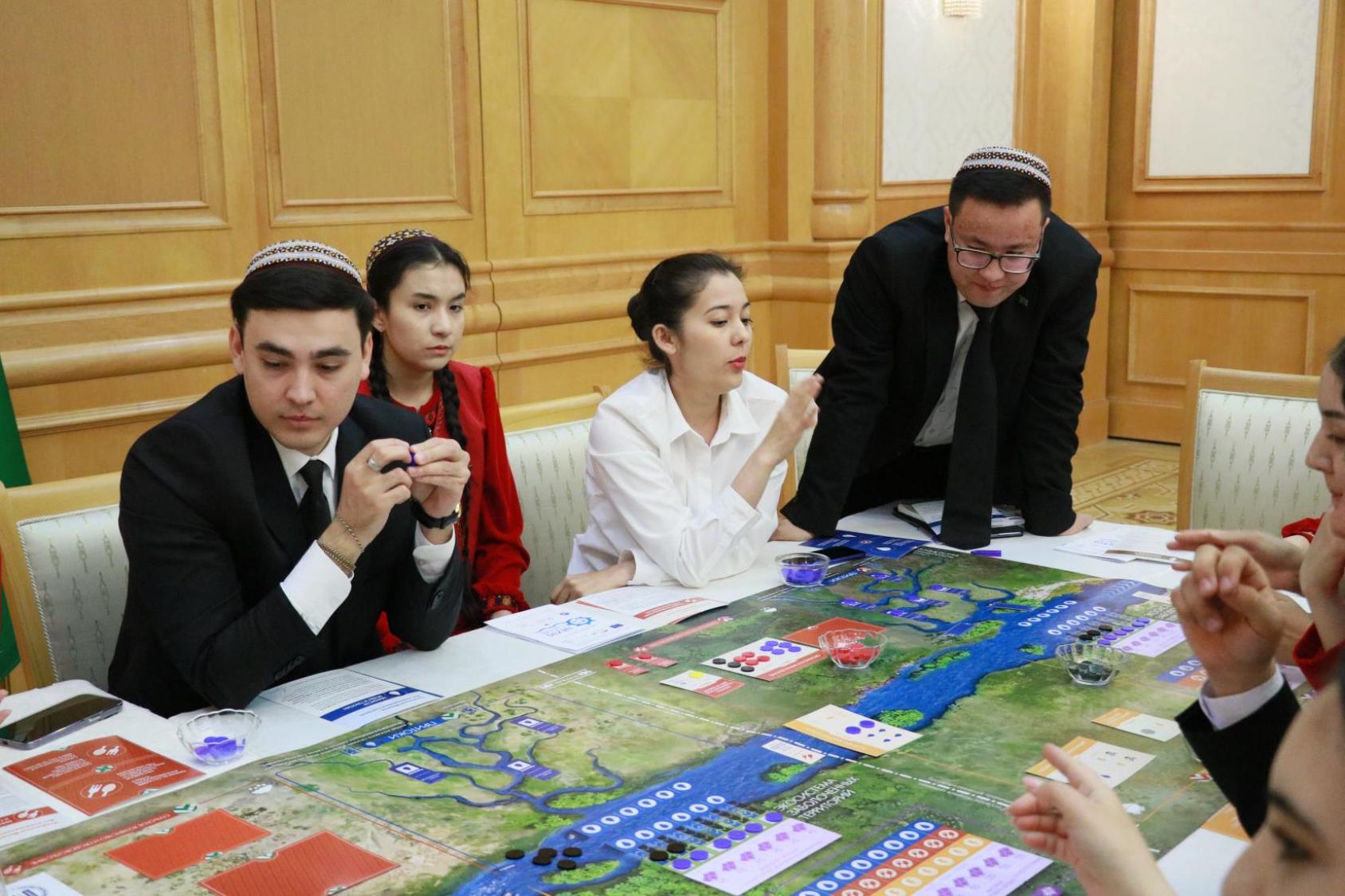 Люди за столом обсуждают карту водных ресурсов.