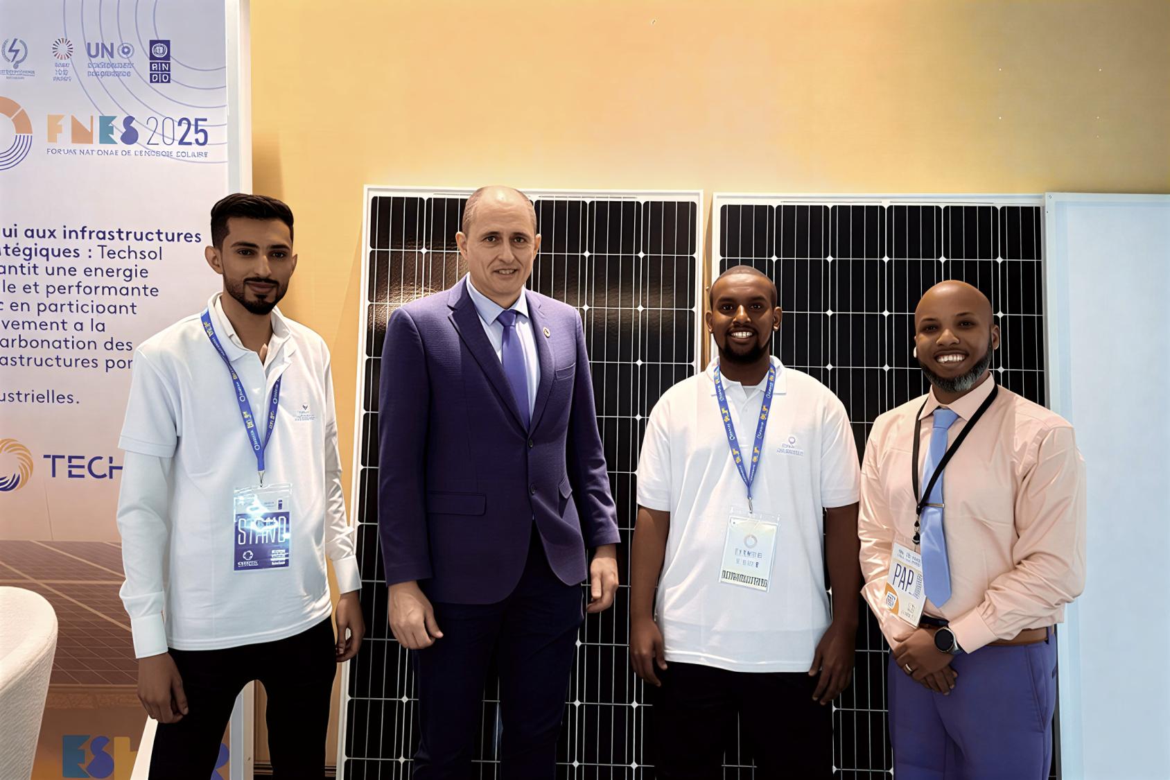A high-level UN official poses for a photo with young solar entrepreneurs in Djibouti.