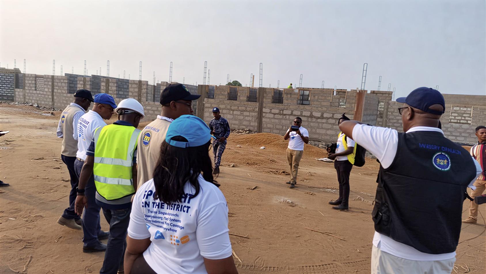 Government employees in Sierra Leone oversee a project site.