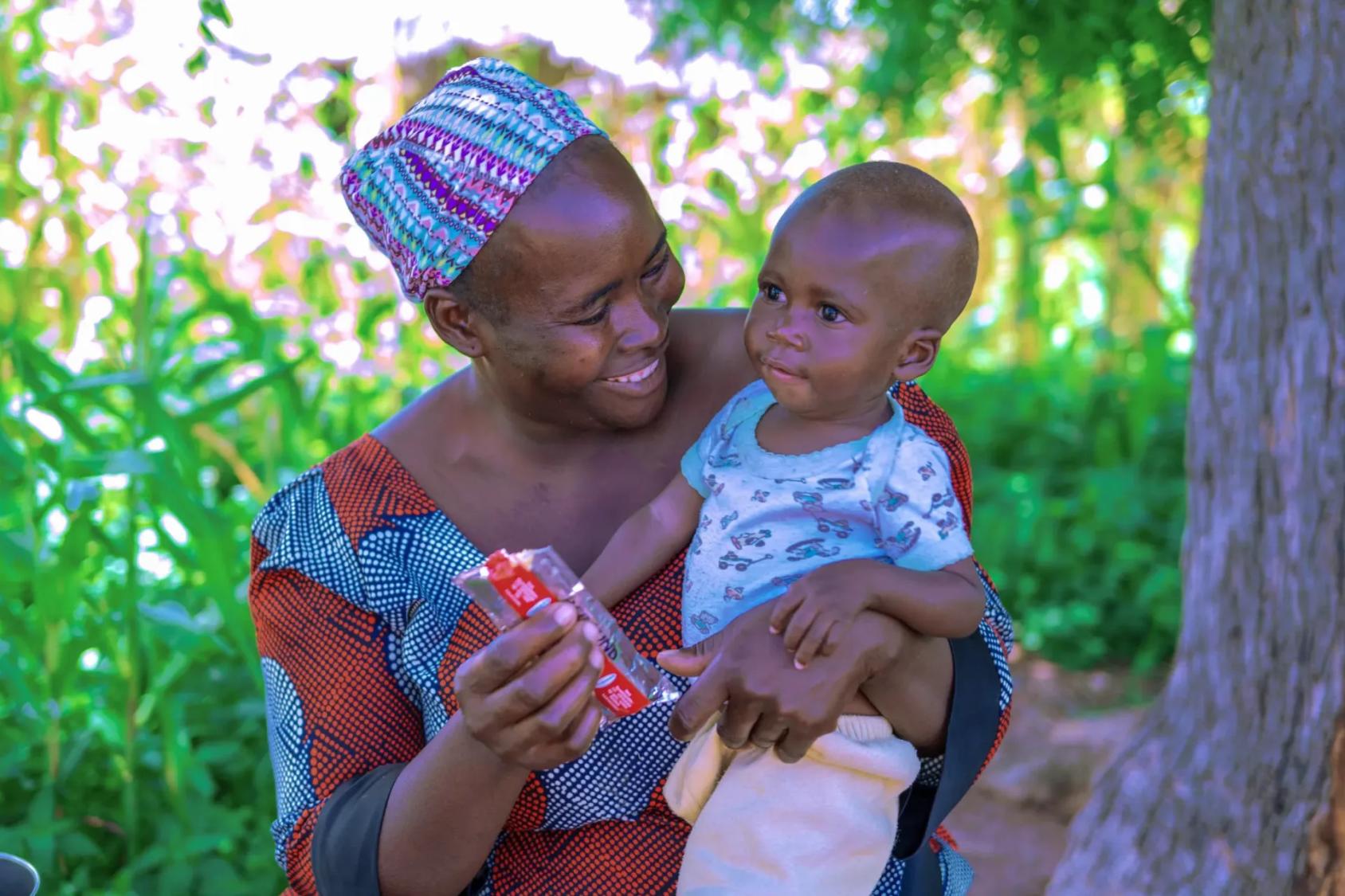 A woman in Nigeria holds her young son.