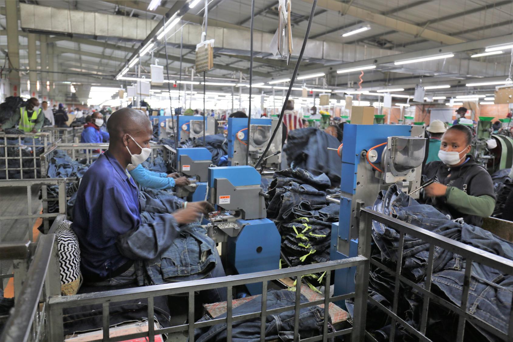 Employees of a fabric factory in Lesotho sew jeans.