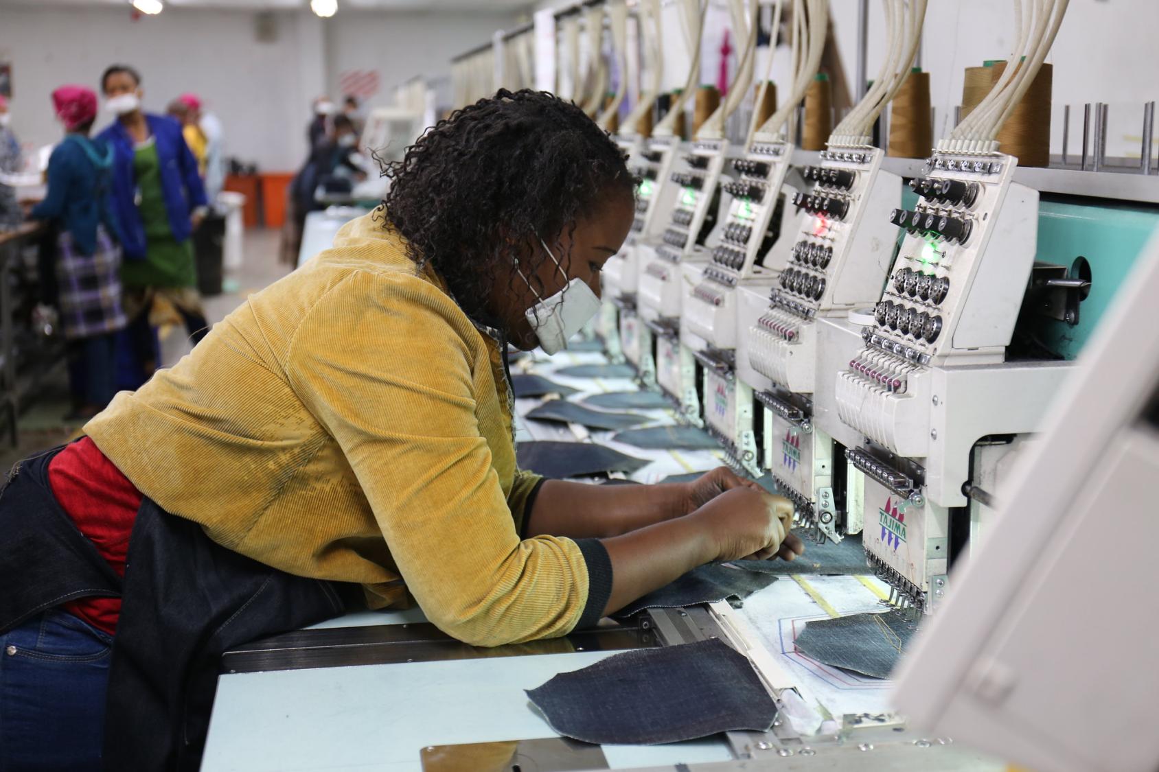 A woman in Lesotho works in a fabrics factory.