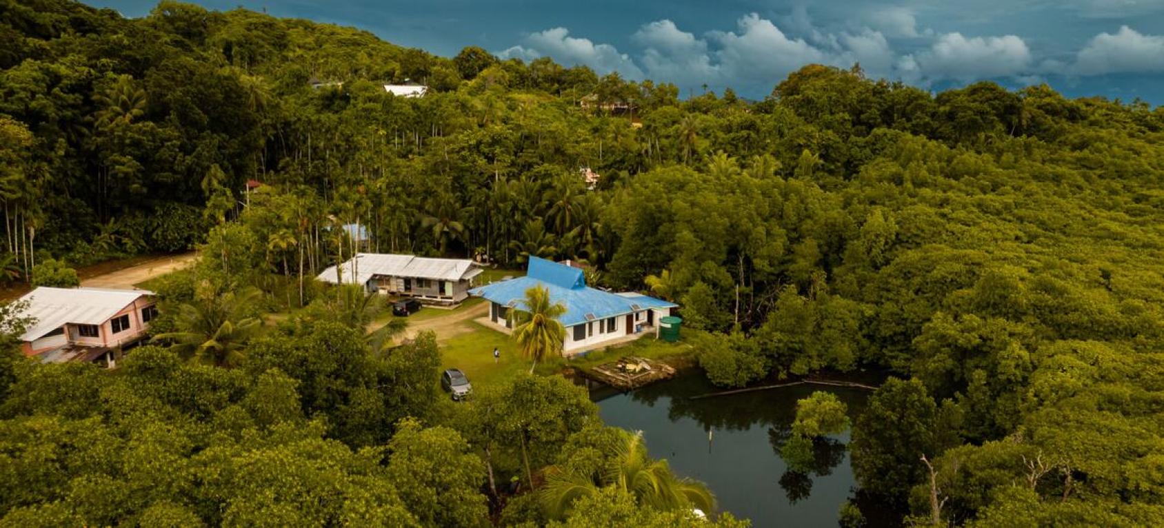 An aerial shot of three climate-resilient shelters in Palau.