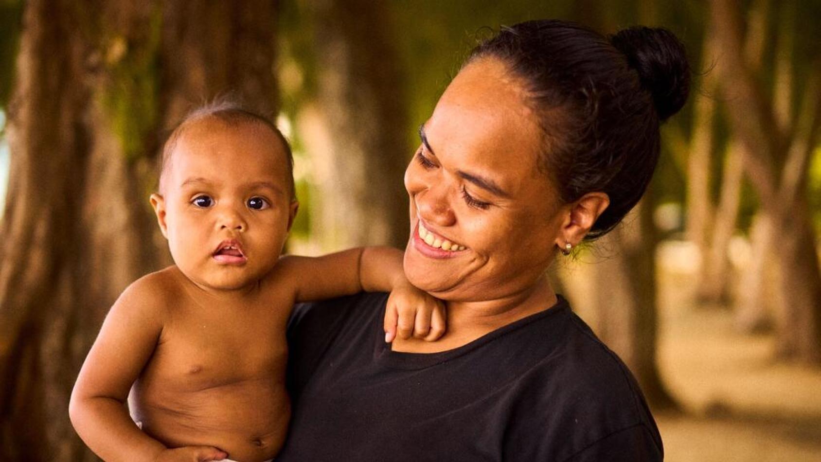 A woman in Palau holds her baby boy.