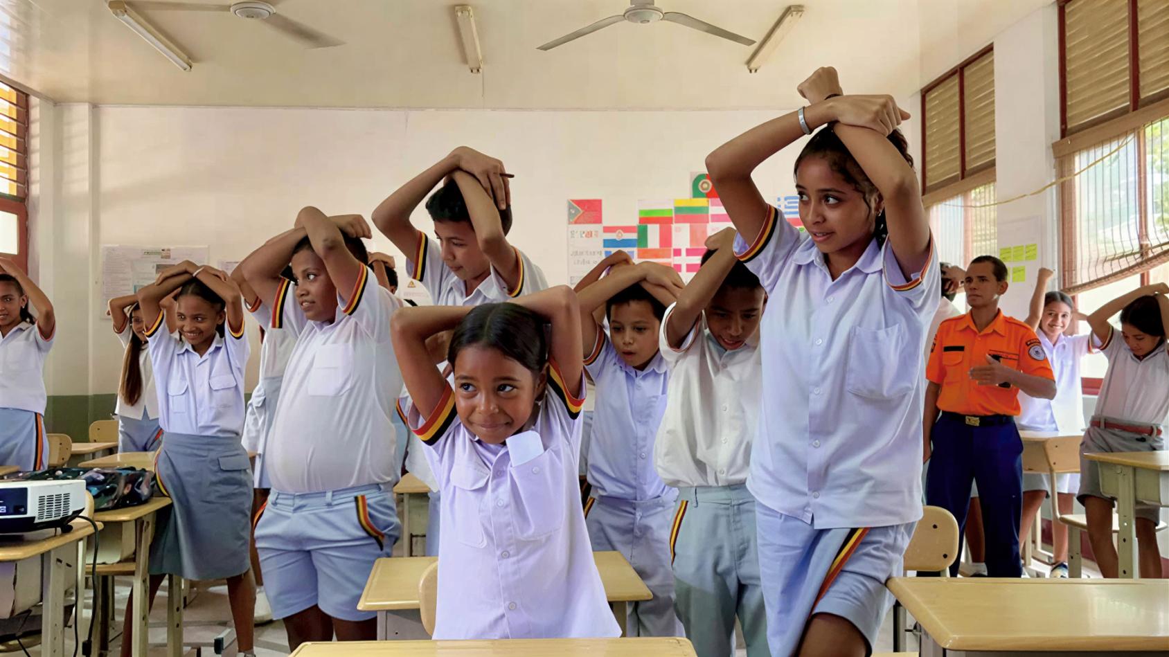 Students in a classroom in Timor-Leste participate in a tsunami drill.