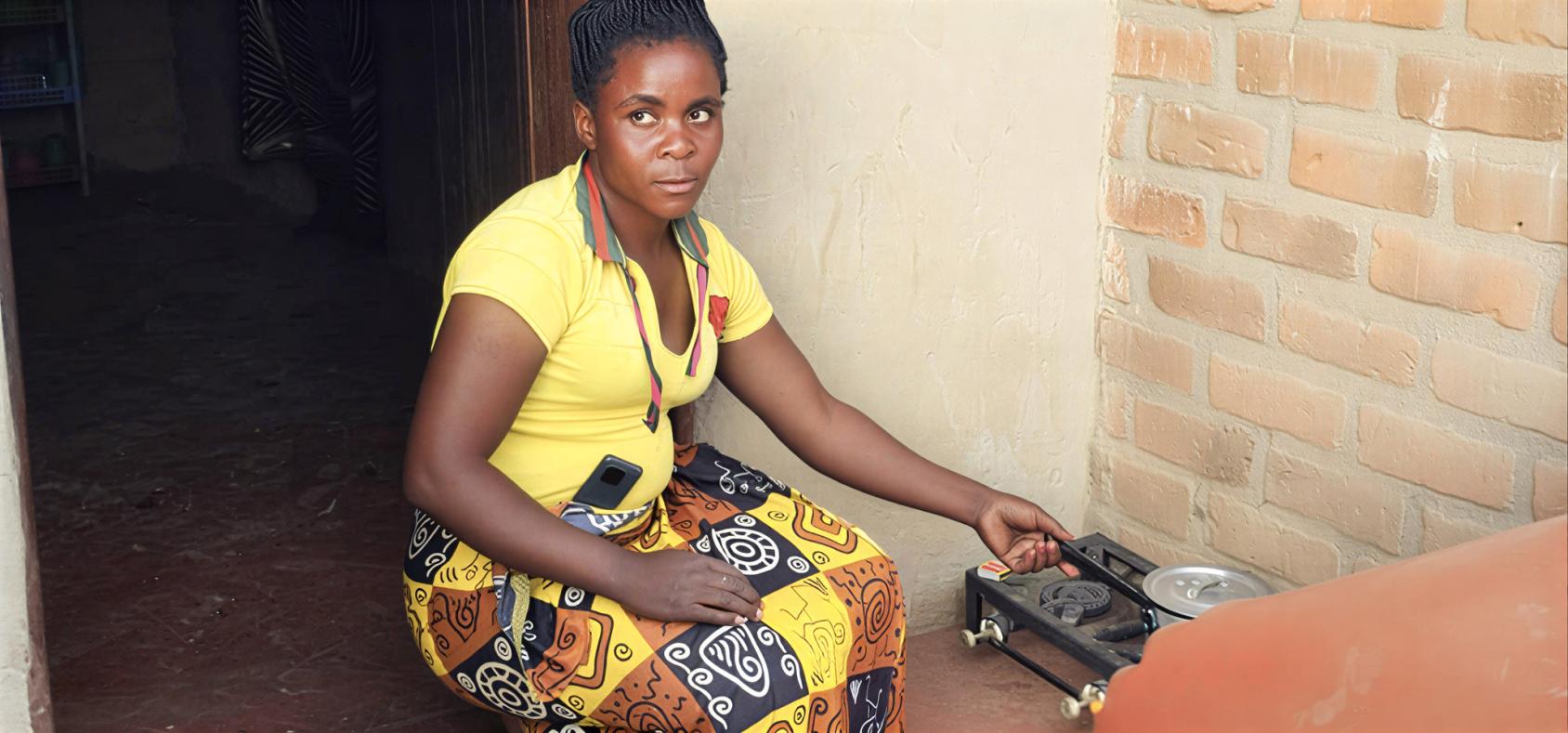 A woman in Zambia cooks food.