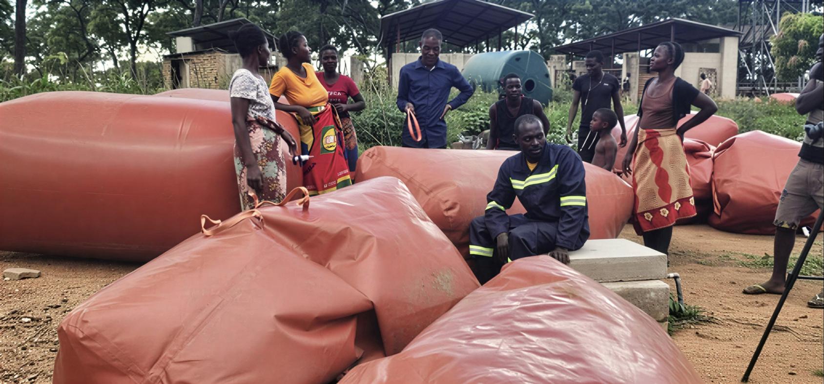 Farmers in Zambia at a biogas collection point.