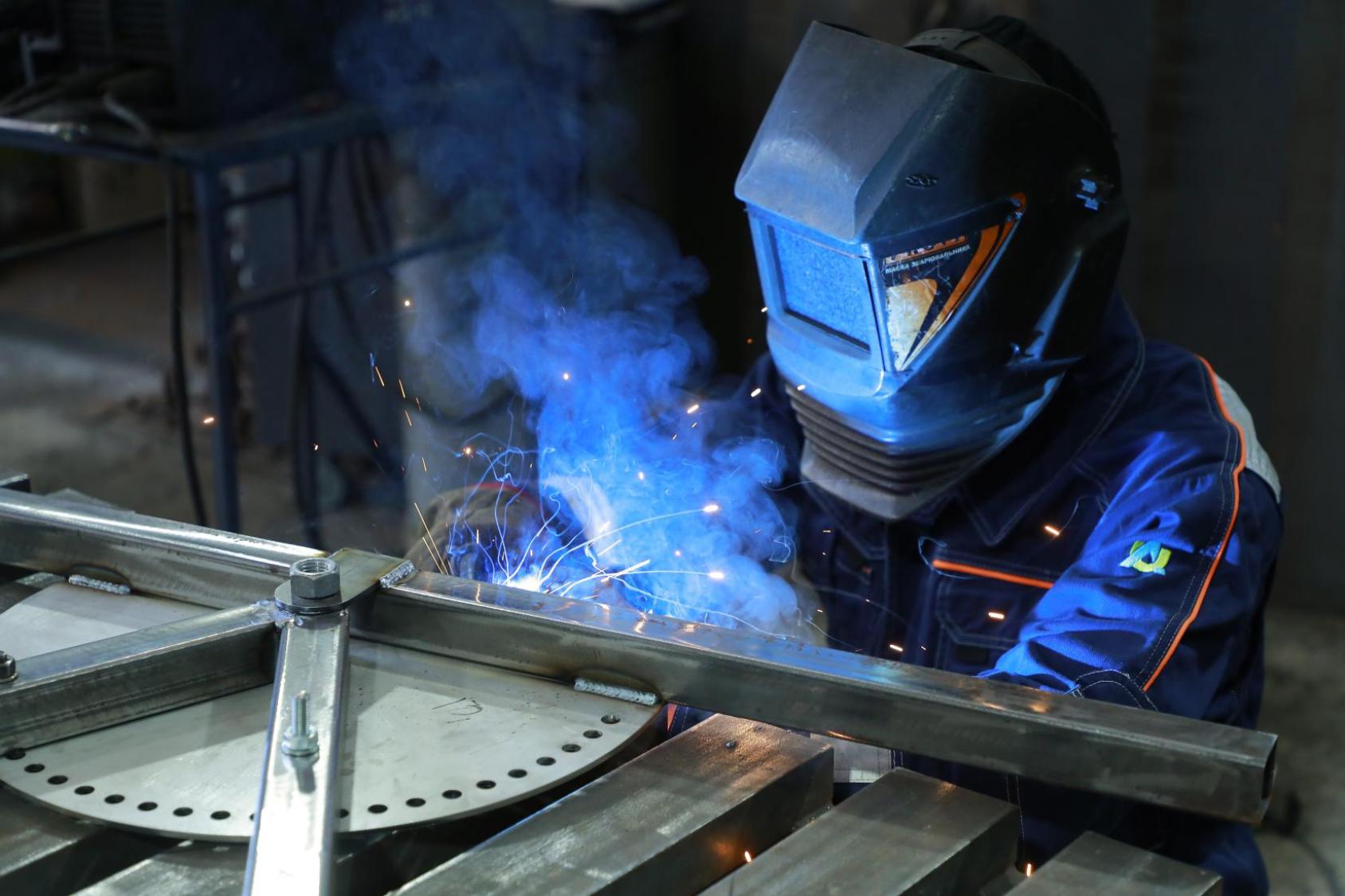 A Ukrainian worker welds in a workshop. 