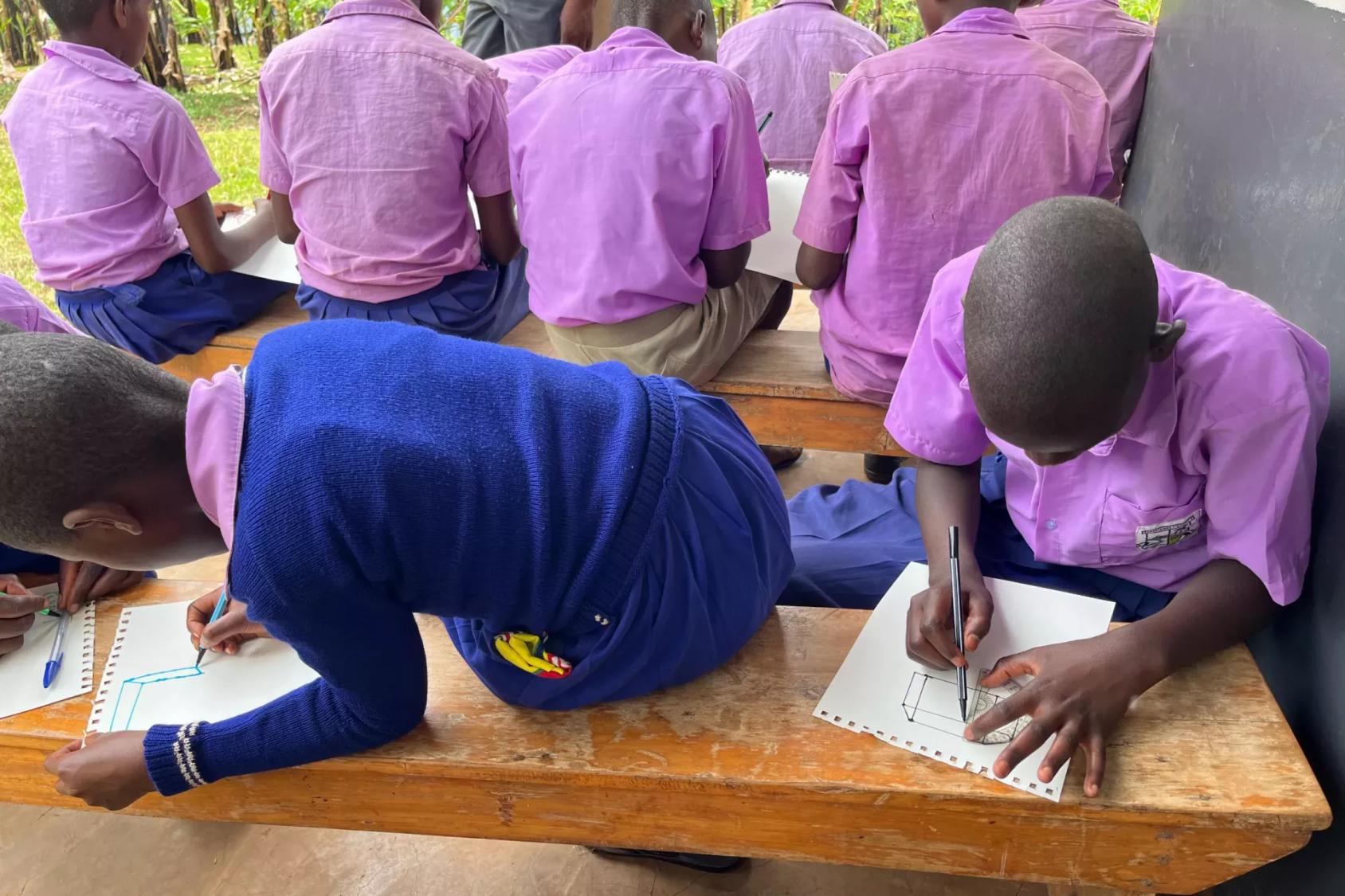 Girls at a school in Uganda work on an assignment.