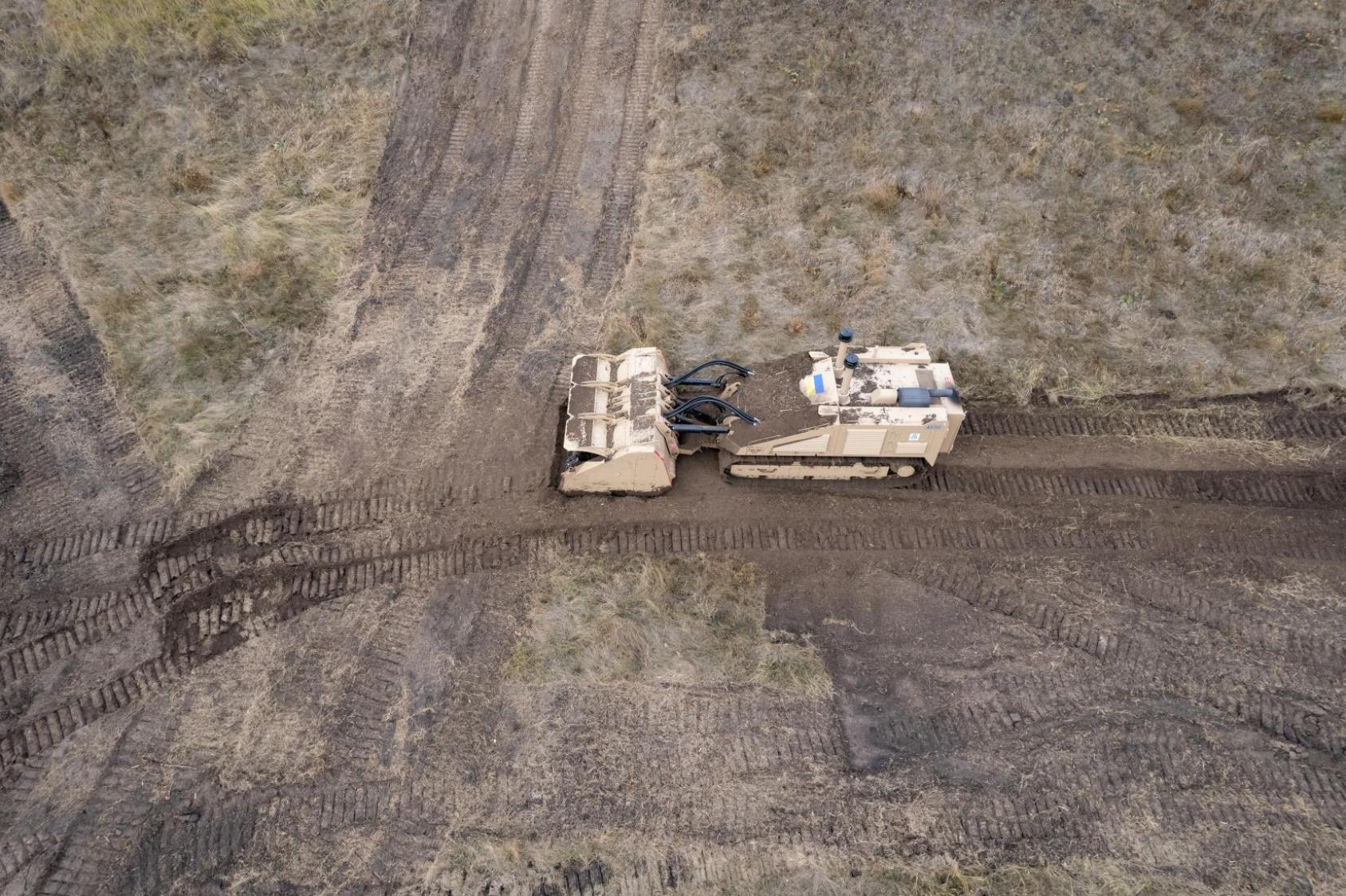 A remotely-operated demining machine sweeps contaminated land in Ukraine.