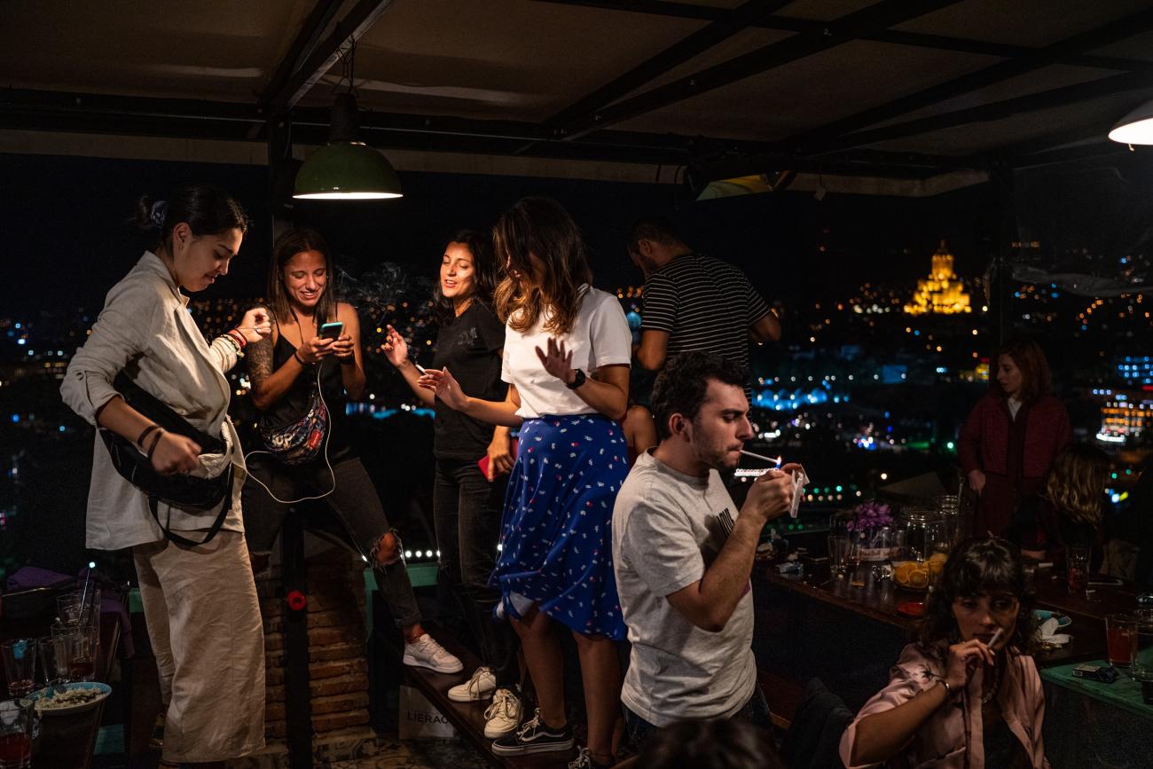 مجموعة من الأصدقاء يرقصون بعد العشاء في تبليسي.