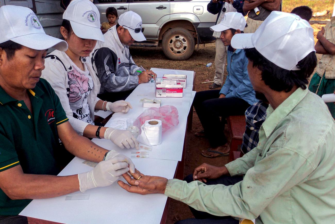 يقوم الموظفون في مركز الوقاية من الملاريا والقضاء عليها بإجراء اختبارات التشخيص السريع للمرض.