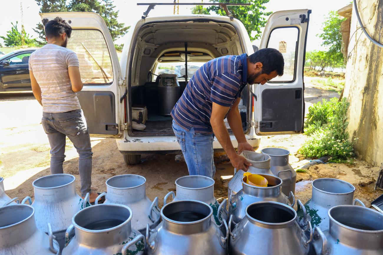 Workers check fresh milk in a Lebanese farm in the Beqaa Valley.