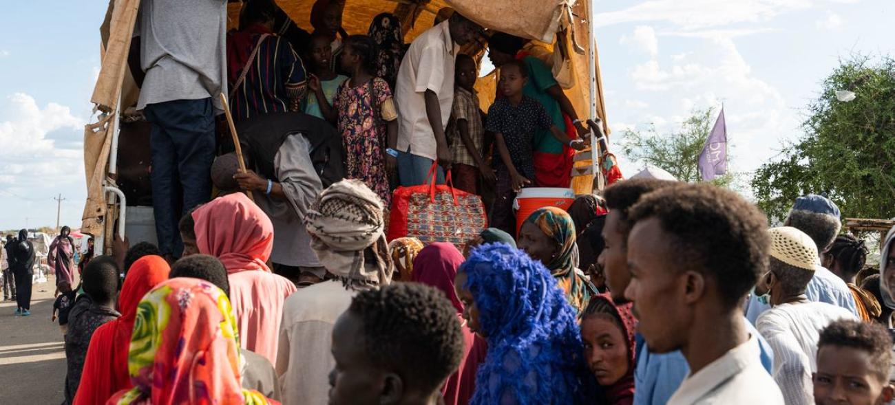 People boarding a cart outdoors, a crowded scene