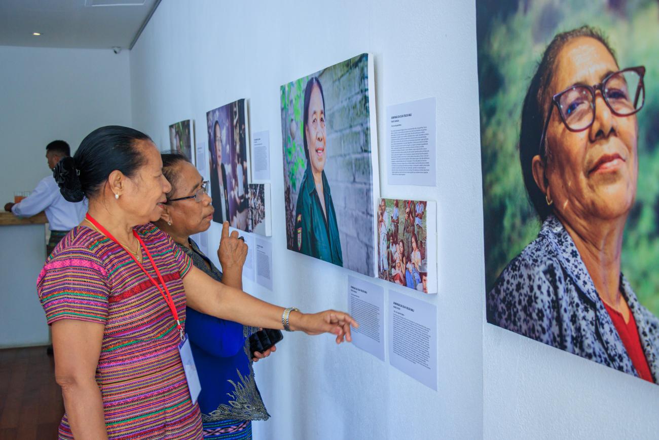 Timorese women veterans observe the canvases before them—portraits that held not just their faces, but the untold stories of their courage and sacrifices with their pictures and stories.