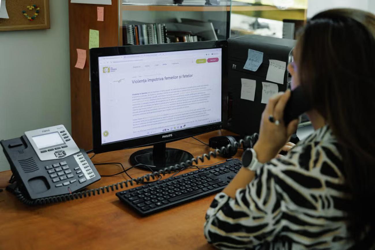 A woman in Moldova looks at a computer screen.